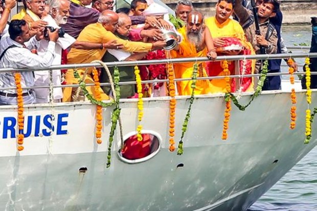 Dilip Das, the head priest of Jagannath Temple, is performing puja of the Sabarmati river with others aboard a river cruise during the Jal Yatra procession of Lord Jagannath in Ahmedabad. (Image Source: PTI)