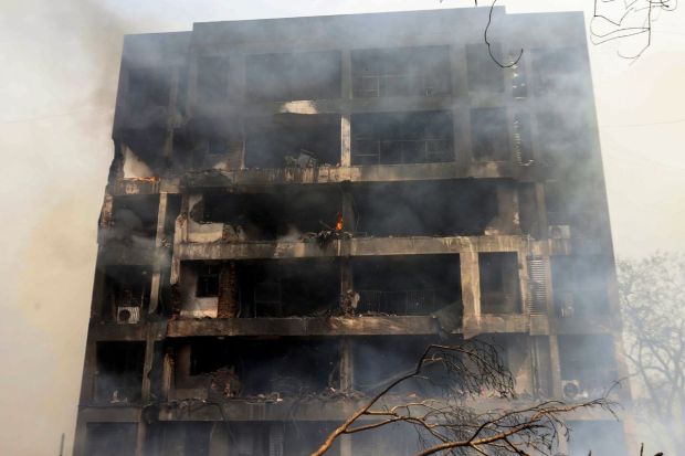 The crash occurred near a doctors’ hostel in the Ramila area, where students were on a lunch break. Witnesses say the plane hit the area suddenly and without warning. (Image Source: PTI) 