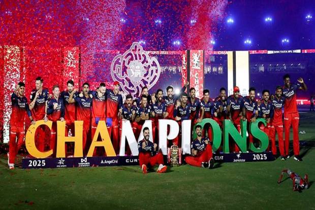 RCB's players celebrate with the trophy after winning the Indian Premier League 2025 final match against Punjab Kings, at Narendra Modi Stadium in Ahmedabad. (Photo source: ANI)