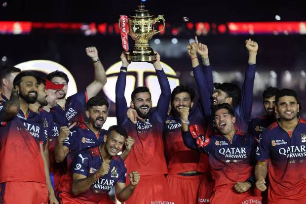 RCB's Virat Kohli lifts the trophy as he celebrates with teammates after winning the Indian Premier League. (Photo source: Reuters)