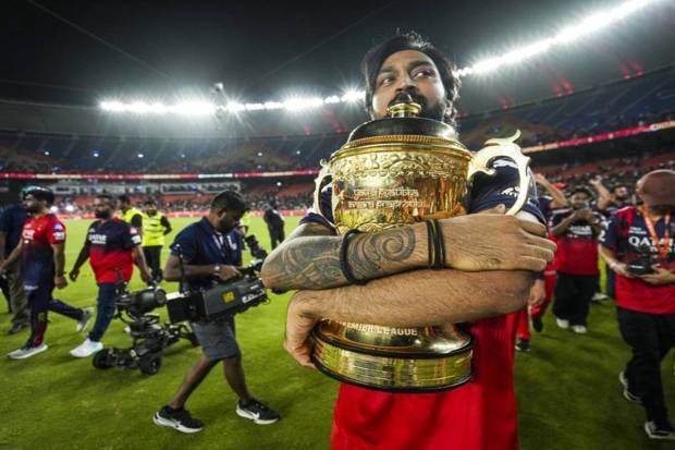 Royal Challengers Bengaluru’s Krunal Pandya posing while holding the Indian Premier League (IPL) 2025 championship trophy. (Photo source: PTI)