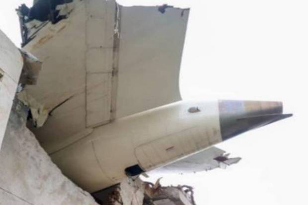 The tail section and right main landing gear are seen inside the northeast wall of the building A. Indicating preliminary heavy structural contact that happened on this side during the downfall. (Photo source: AAIB)