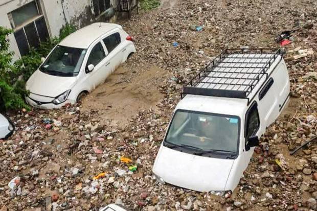 Vehicles lie stuck in silt and debris after cloudburst-triggered flash floods at Karsog, in Mandi district, Tuesday, July 1, 2025. (Photo source: PTI)