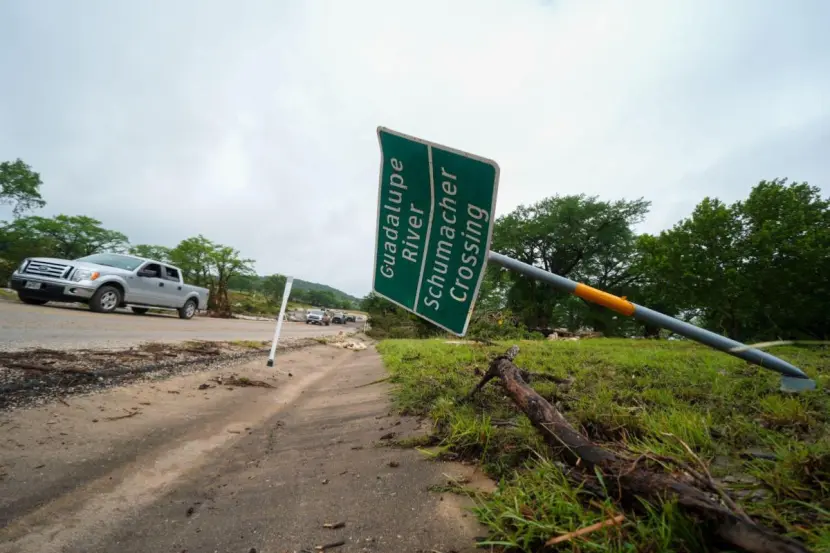 A downed sign is seen near a crossing of the river after the flood.