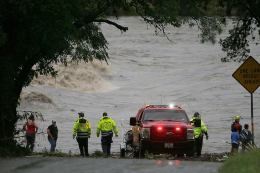 First responders scan the banks of the Guadalupe River for individuals swept away by flooding.