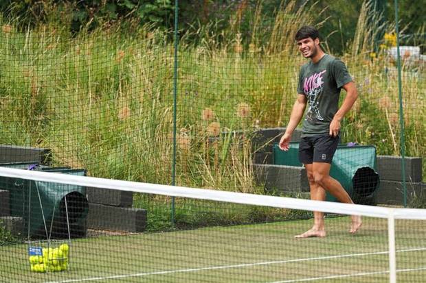 Spain's Carlos Alcaraz walks barefoot on the grass during a session on one of the practice courts on day ten at the Wimbledon Tennis Championships in London, Wednesday, July 9, 2025. (Photo source: AP)