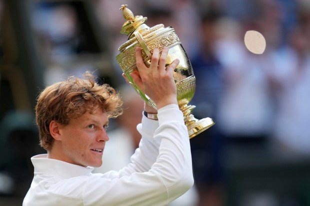 Sinner holds the Wimbledon trophy high after defeating Carlos Alcaraz in the men’s singles final in London. (Photo: AP)