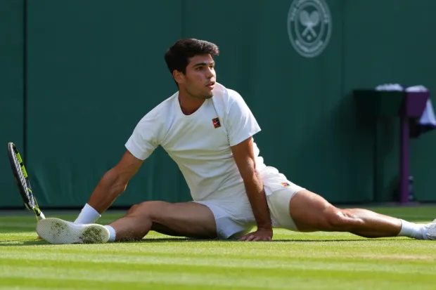 Carlos Alcaraz slides as he returns to Jannik Sinner of Italy during the men's singles final match at the Wimbledon Tennis Championships in London. (Photo: AP)
