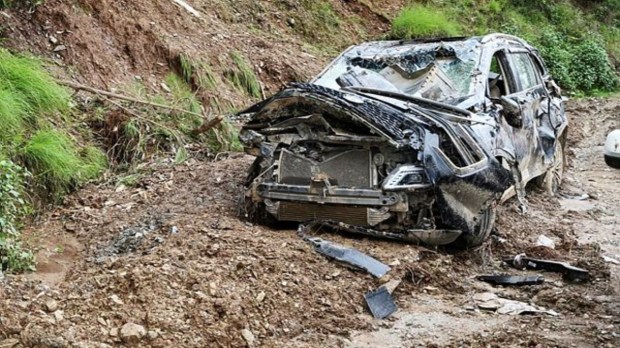 A view of the damaged car following cloudburst, in Mandi on Saturday. (ANI Photo)