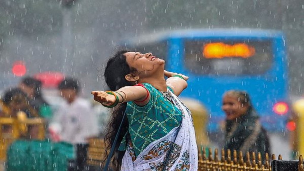 A woman enjoys rain, in Bengaluru, Karnataka, Sunday, July 20, 2025. (PTI Photo)