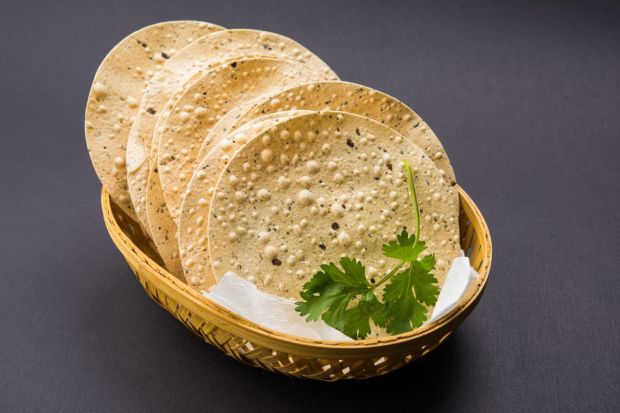 Papadam: This crisp fritter is made with rice or khichiya and can also be made of lentil. A crunchy pair with rice, this is a staple across all Onam Sadhya thalis. (Image: Canva)