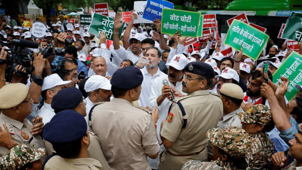 INDIA alliance MPs, including Leaders of Opposition Rahul Gandhi and Mallikarjun Kharge, took out a protest march on Monday (August 11, 2025) from Parliament House to the Election Commission against the Special Intensive Revision (SIR) of electoral rolls in Bihar and alleged “vote chori” but were stopped midway by the police and detained citing disruption. Police put up barricades on the way to prevent the MPs, protesting the voter roll revision in Bihar and the alleged poll rigging, from marching forward. (Photo Source: Official Twitter handle @INCIndia)