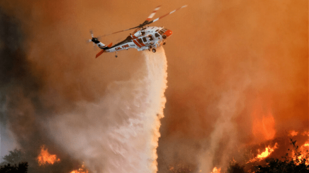 Helicopters deployed: Cattle ranches near the fire were forced to evacuate as the state authorities had engaged aircrafts to conduct water drops on rapidly spreading flames. (Photo Source: Reuters)