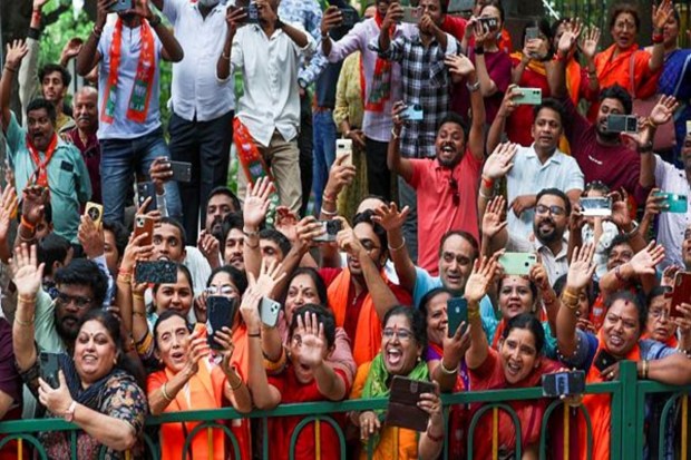 People gather during a roadshow of Prime Minister Narendra Modi, in Bengaluru. (Image Source: PTI)