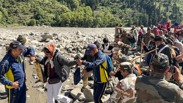 This image, captured on August 8, shows people being evacuated from flash flood-hit Dharali, in Uttarkashi, by the Indian Army and SDRF in a joint operation.  (Photo Source: PTI)