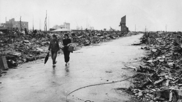  In this September 8, 1945, file photo released by the US Air Force, two people walk on a cleared path through the destruction resulting from the August 6 detonation of the first atomic bomb in Hiroshima. (Photo Source: Associated Press)