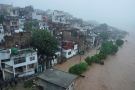 People watch a swelling River Tawi from the roof of their houses in Jammu | Representational image/AP