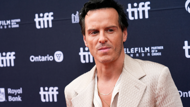 Andrew Scot, the beloved preist from 'Fleabag' greets fans and flashes a grin while arriving for the 'Wake Up Dead Man' premiere at the Princess of Wales Theatre, adding wit and warmth to TIFF’s celebrations. (Photo: Associated Press)