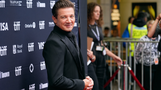The famous 'Hawkeye', Jeremy Renner poses on the Princess of Wales Theatre steps for the premiere of 'Wake Up Dead Man: A Knives Out Mystery.'