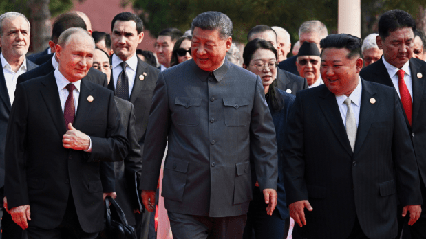 Chinese President Xi Jinping, center, and foreign leaders including Russia President Vladimir Putin, center left, and North Korean leader Kim Jong Un, center right, walk to Tiananmen Rostrum ahead of a ceremony. The three leaders were photographed walking together towards the ceremony, a striking image broadcast on giant screens in the capital where they were joined by heads of state from Pakistan and Indonesia. (Photo Source: Associated Press)