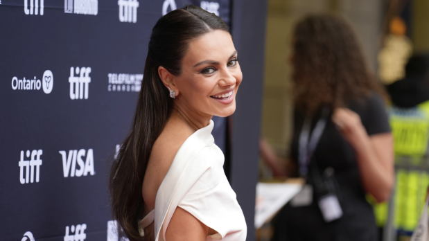 Mila Kunis poses for photographers and greets fans at the premiere of 'Wake Up Dead Man: A Knives Out Mystery' at the Princess of Wales Theatre during the Toronto International Film Festival on Saturday.