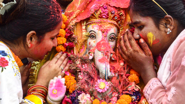 People take part in a procession for the immersion of an idol of Lord Ganesha during the Ganesh Chaturthi festival celebrations, in Kanpur, Uttar Pradesh.