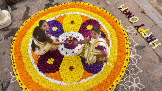 Women make a pookalam (floral rangoli) as part of Onam celebrations, in Chikkamagaluru, Karnataka, Friday, Sept. 5, 2025. (Photo Source: PTI)